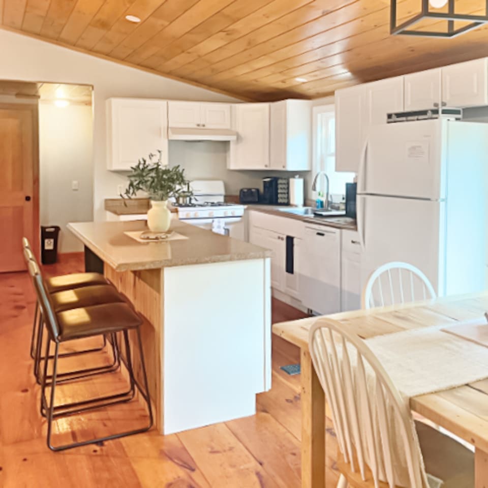Fully stocked kitchen with big island that fits perfectly into the open floor plan of the home!  