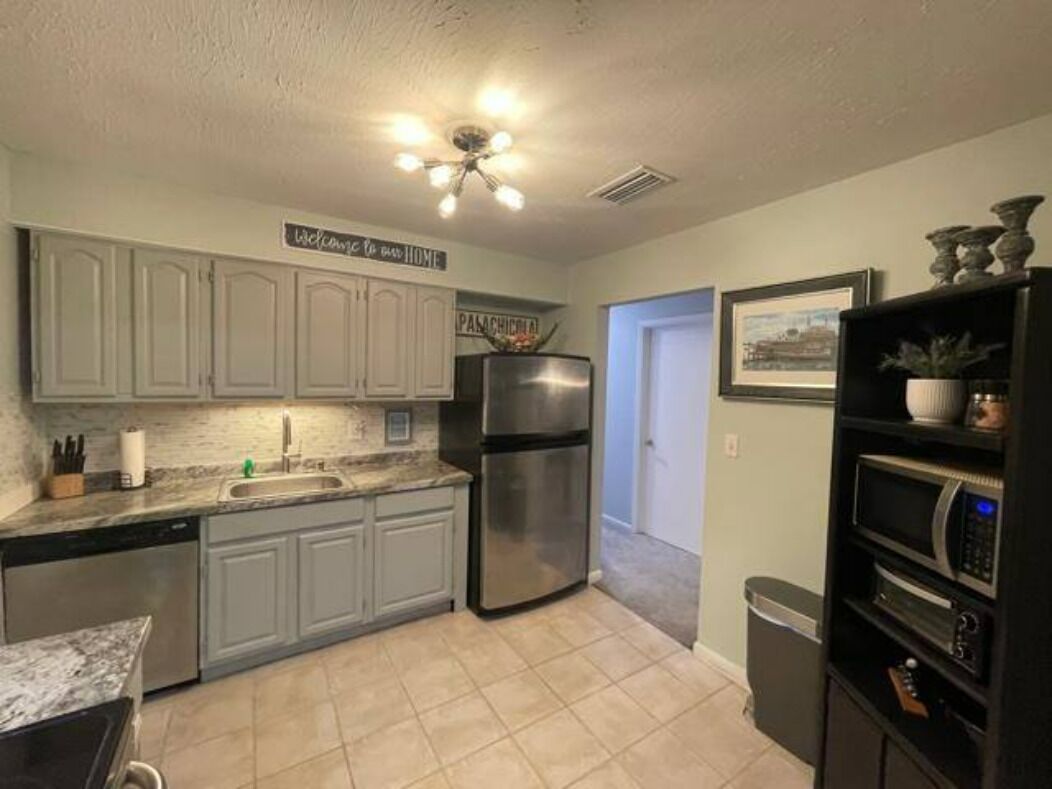 Full kitchen with stainless steel refrigerator