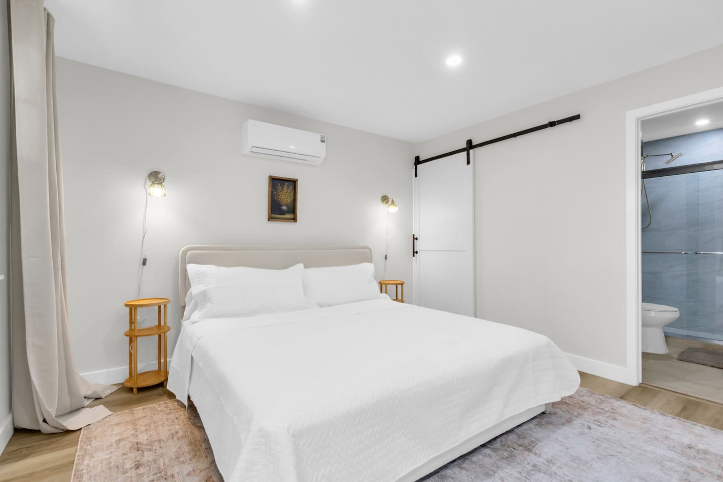 Enjoy a relaxing stay with a plush king bed, sliding barn door closet, and a fully stocked bathroom complete with a shower and Ginger Lily Farms essentials.