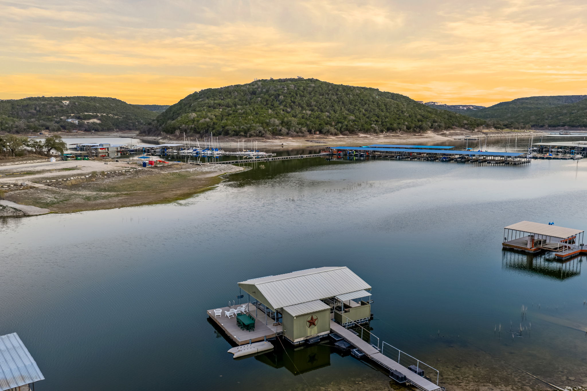 Scenic aerial view of the lake and nearby marina at golden hour.