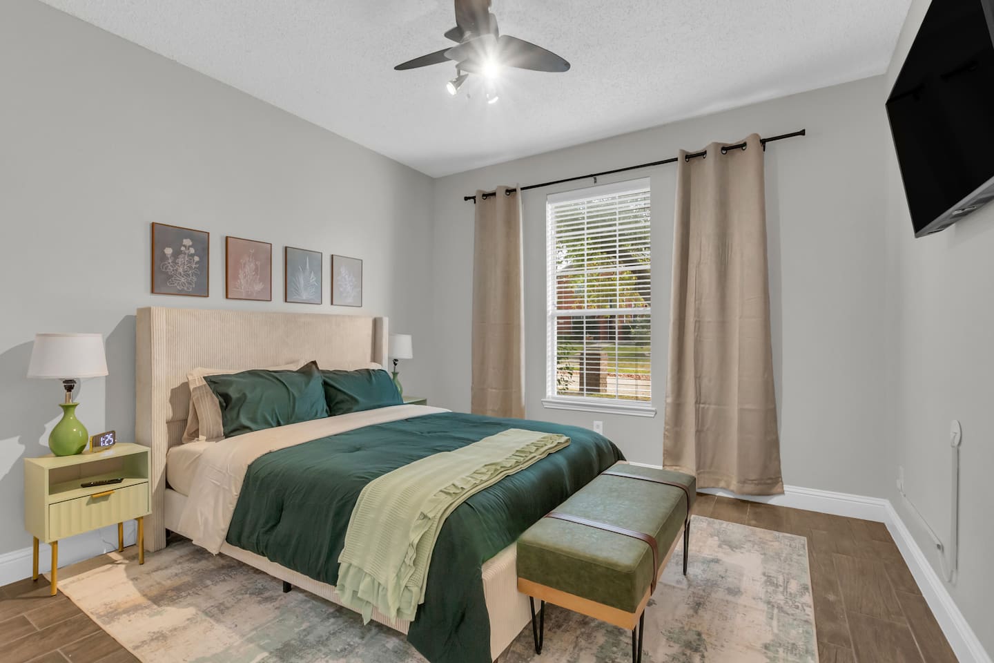 Spacious third bedroom featuring a comfortable queen bed, room-darkening blinds, ceiling fan, fresh bed linens, hangers, and high-speed Wi-Fi.
