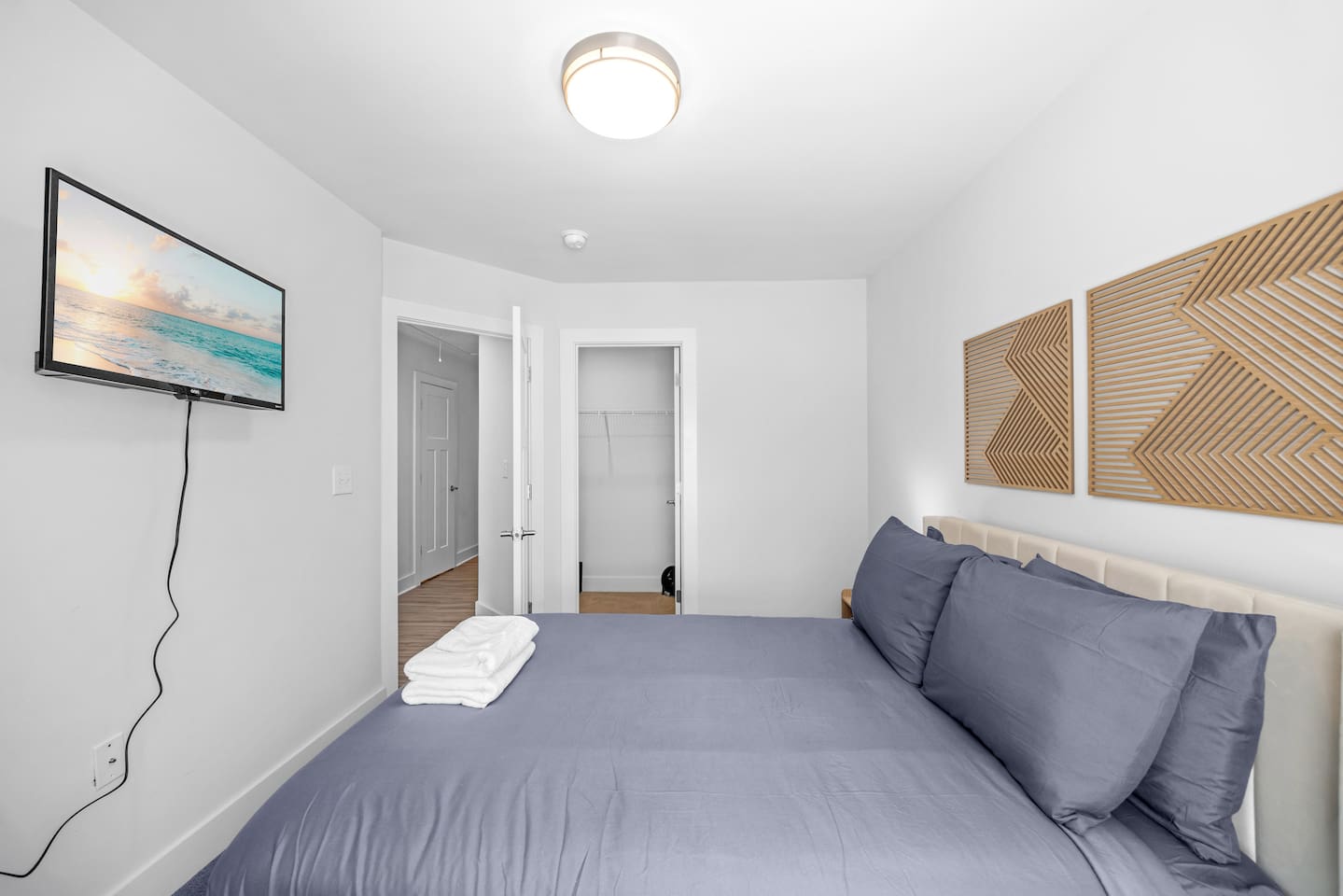 Enjoy your favorite shows from bed with a mounted TV and convenient closet space.