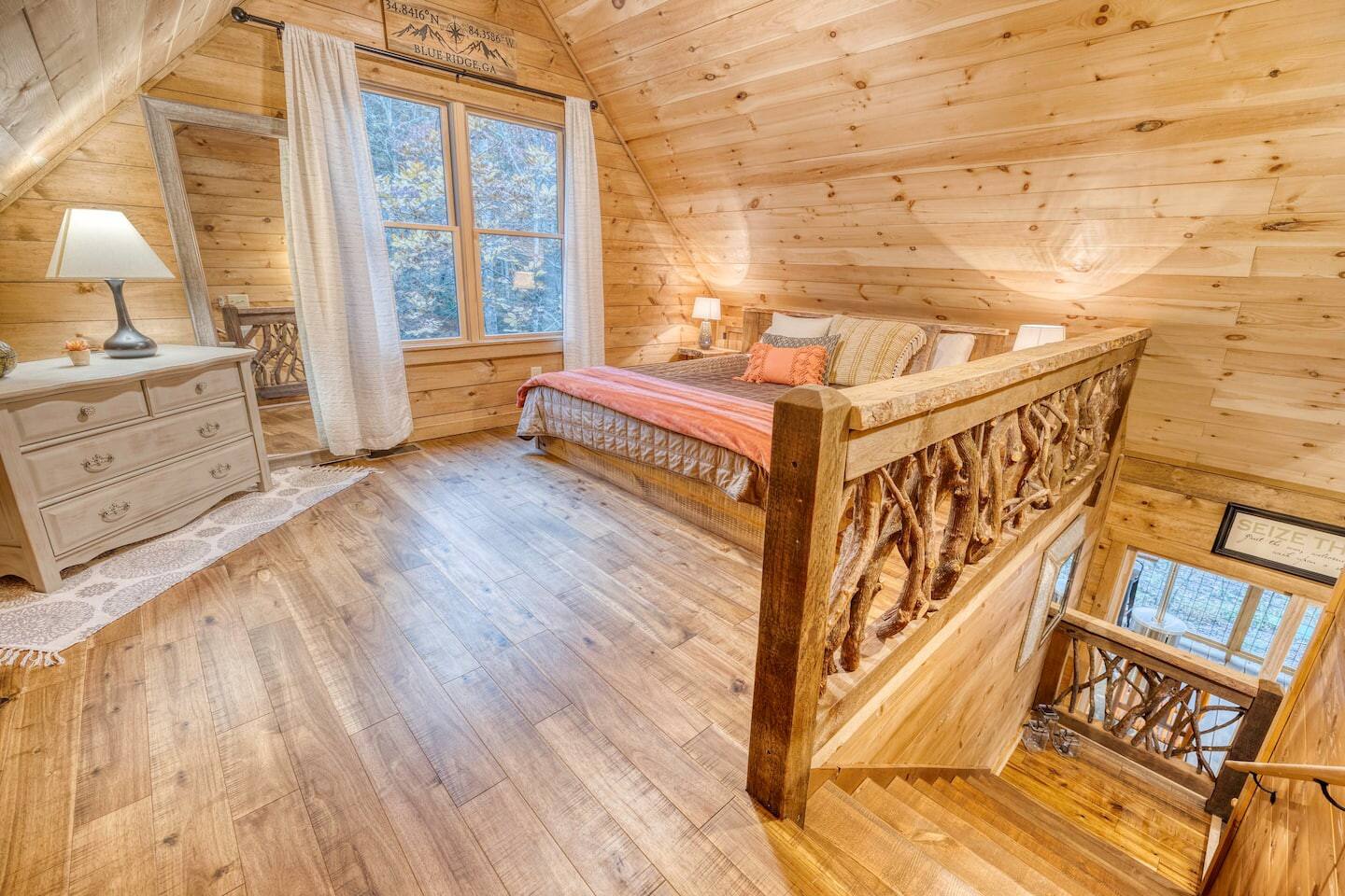  Our upstairs bedroom awaits, a haven of tranquility where plush bedding and thoughtful touches promise restful nights and rejuvenating mornings in the heart of our cozy cabin.