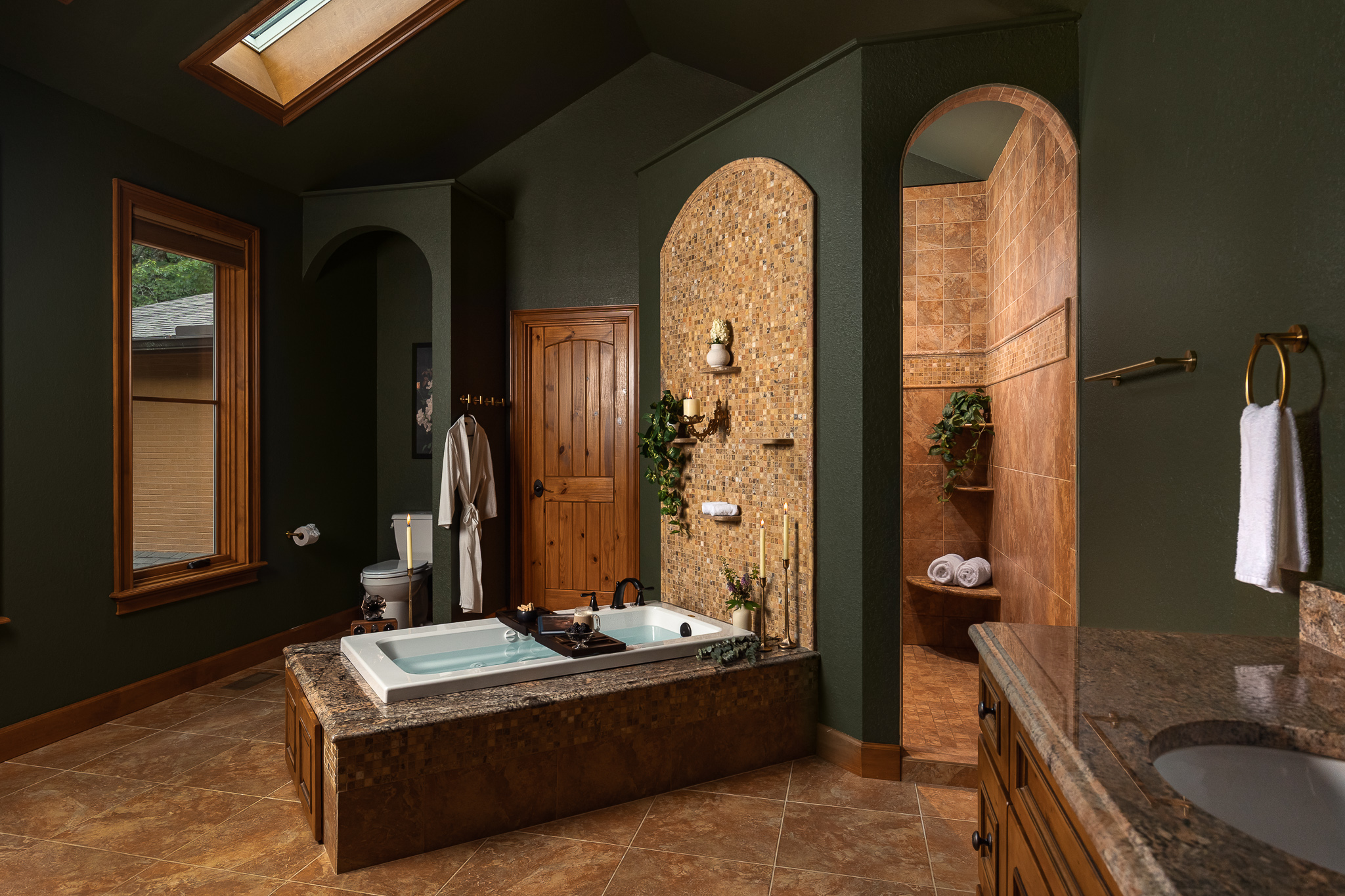 {Bedroom 1 Ensuite Bathroom} The spacious primary ensuite feels like a private spa, with a soaking tub, dramatic walk-in shower, and rich mountain-lodge finishes.