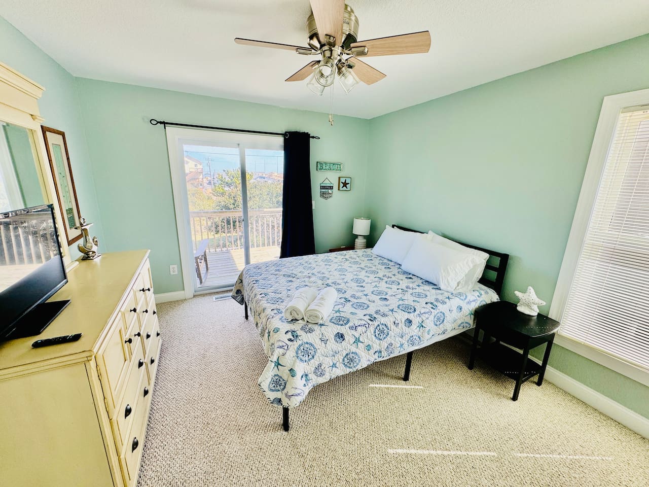 Bright Queen room with sliding door to private deck.