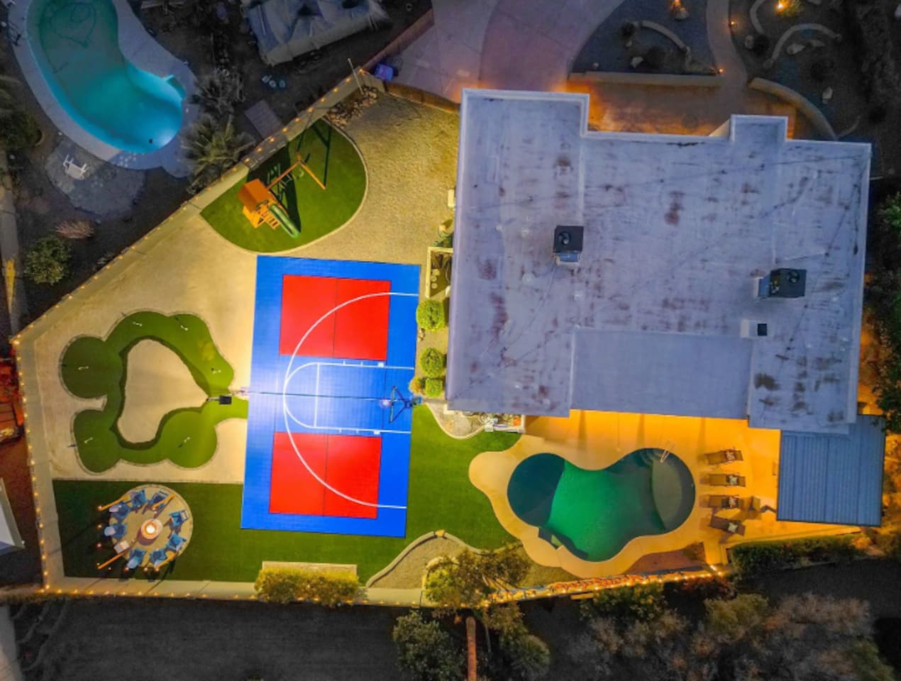 Every amenity laid out at once: pool, court, putting green, playground — a full day of options without leaving the yard.