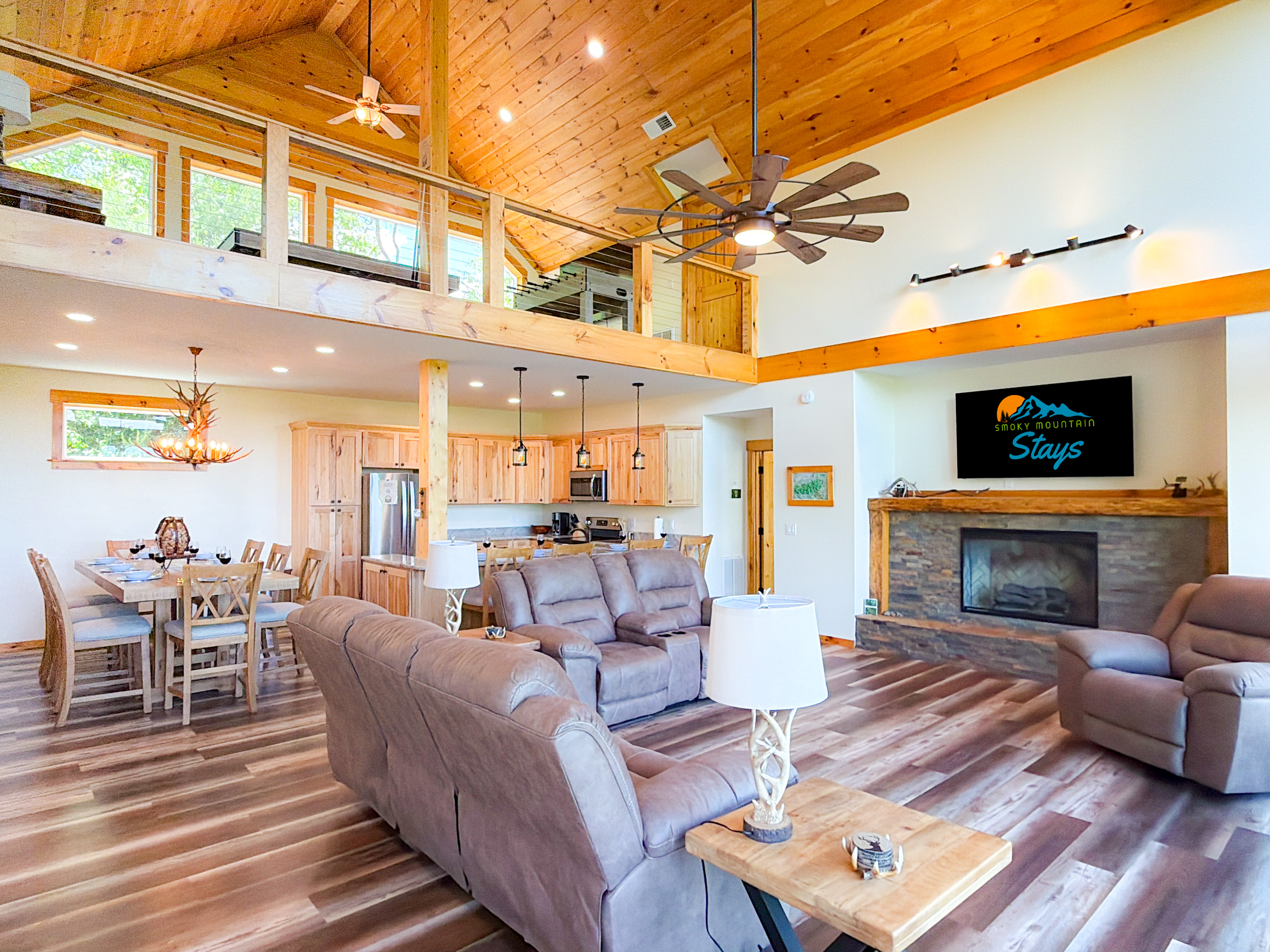 The living room features a 65" Smart TV, electric fireplace for cold nights, and plenty of comfy seating for your group.