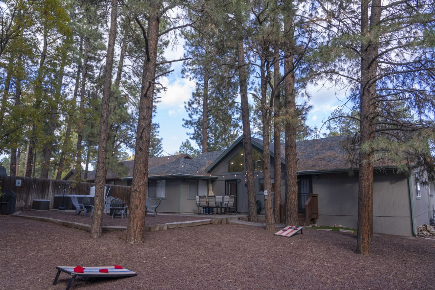 Outdoor space with pine trees, seating, and a peaceful setup for evenings outside.