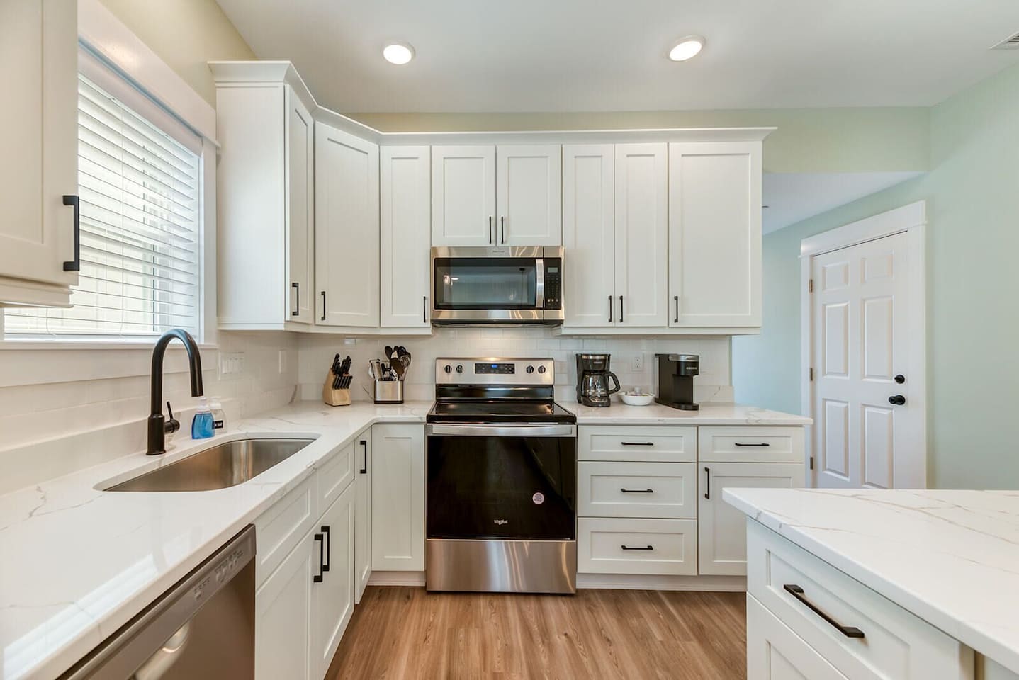 Modern coastal kitchen with stainless steel appliances and everything needed for easy vacation meals.