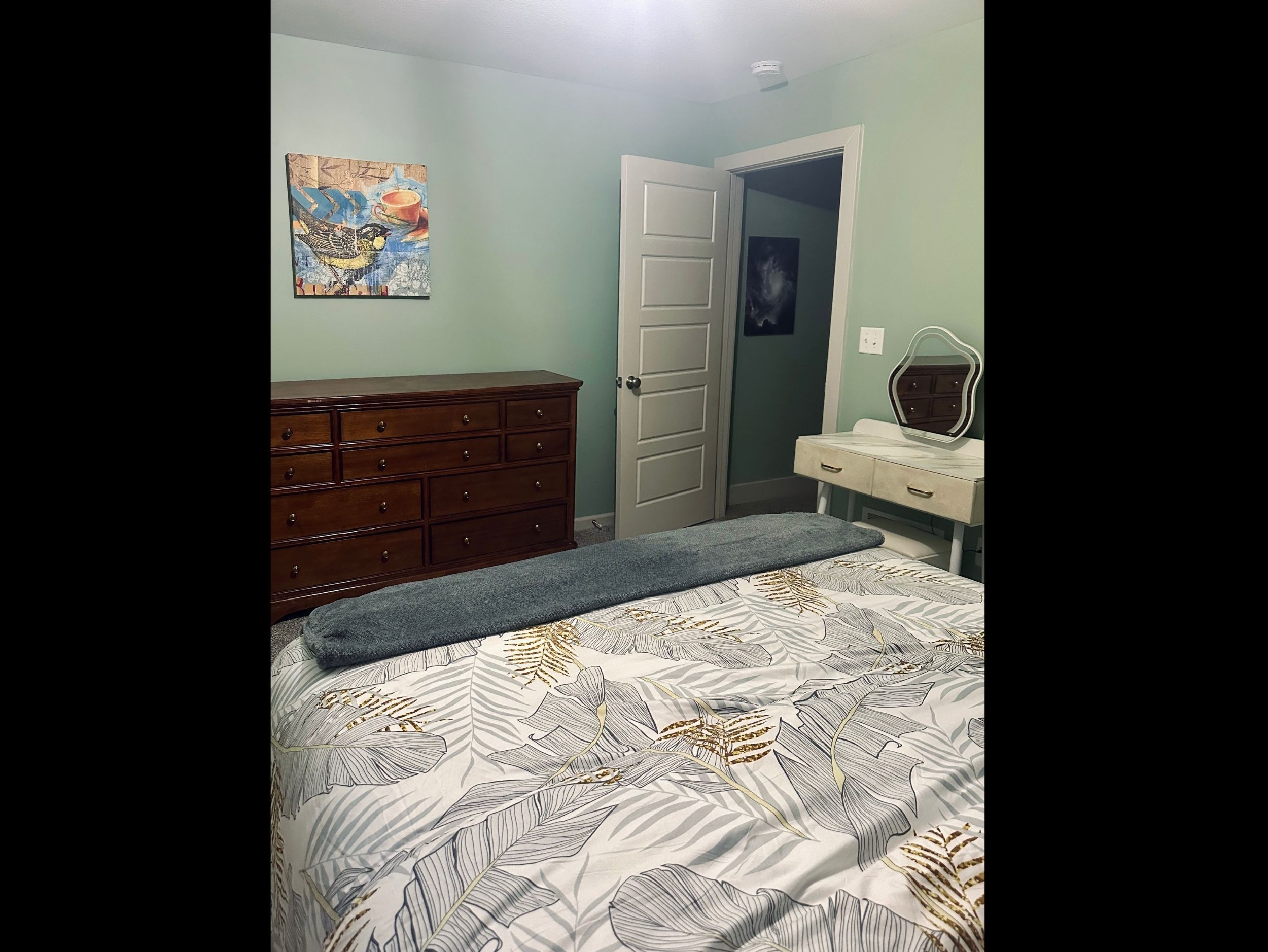 Alternate angle of the welcoming queen bedroom, highlighting its calm atmosphere and spacious layout.