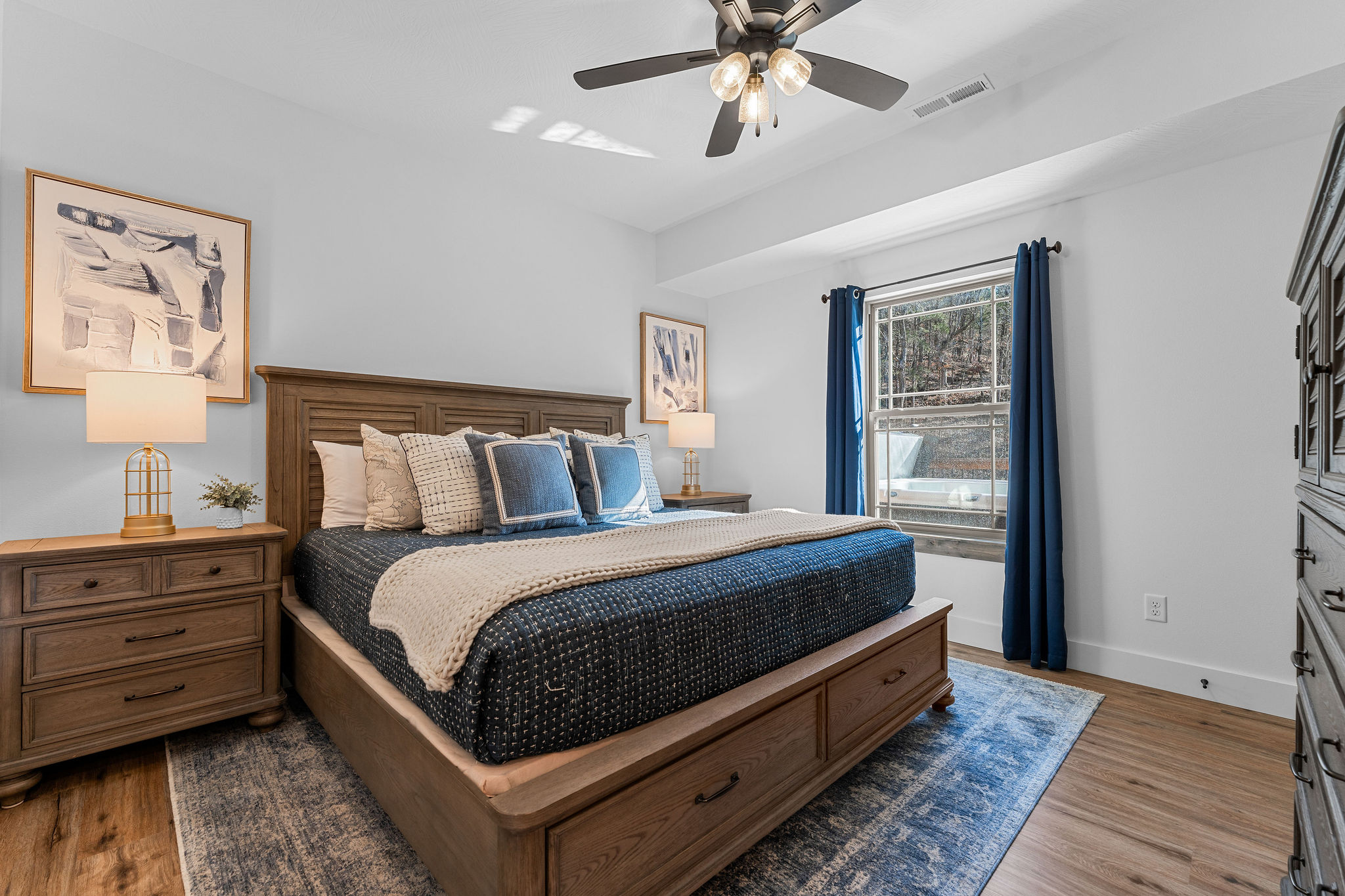 Bedroom three upstairs has a comfortable king bed, with cozy bedding and natural light.