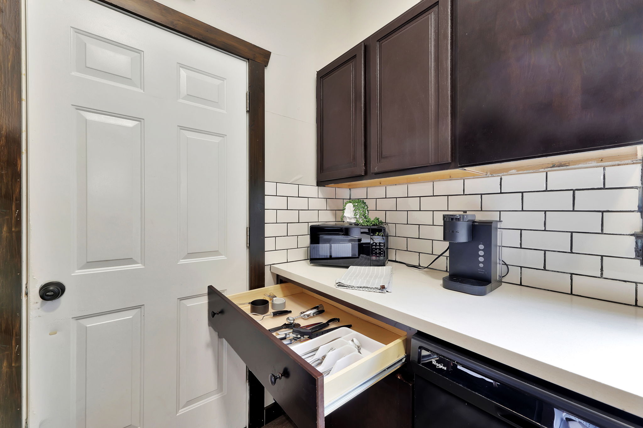 Well stocked kitchen with utensils.