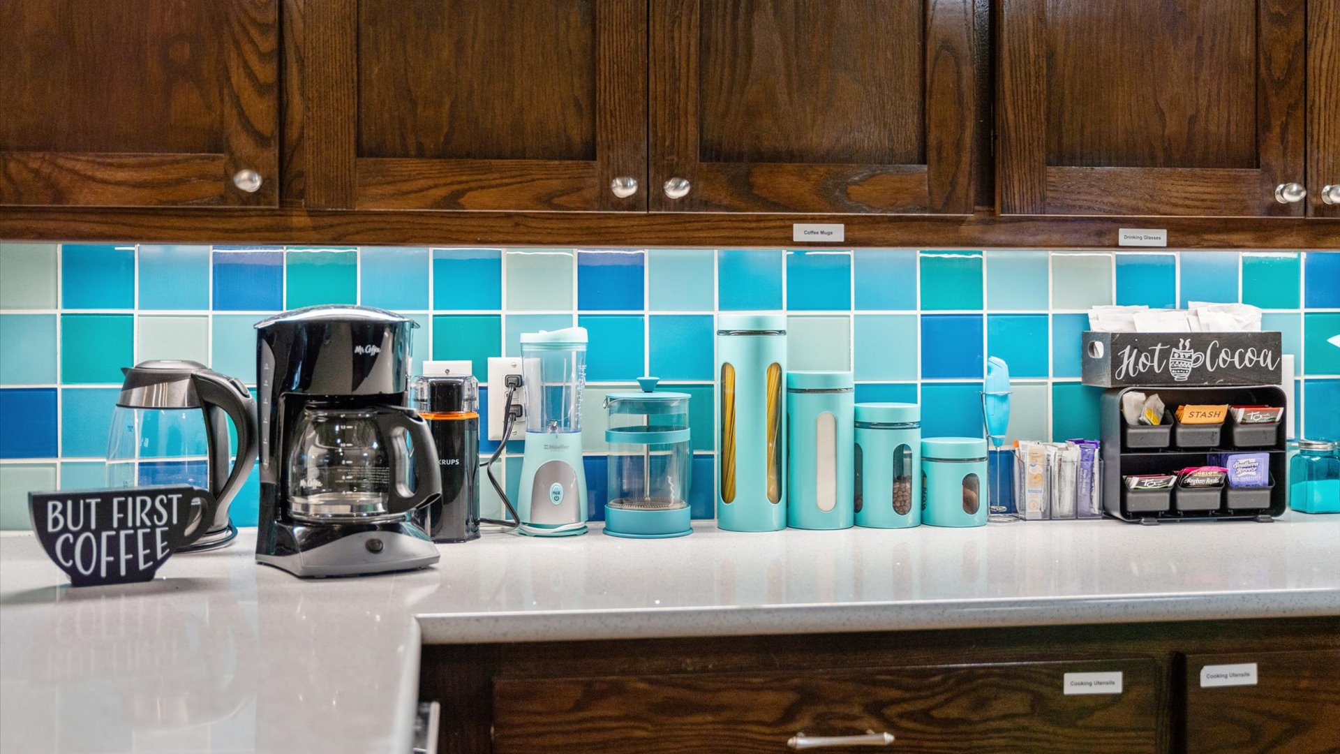 A well-stocked coffee and beverage station featuring a coffee maker, French press, and hot cocoa bar—perfect for starting your morning or unwinding with a warm drink in this wonderful kitchen.