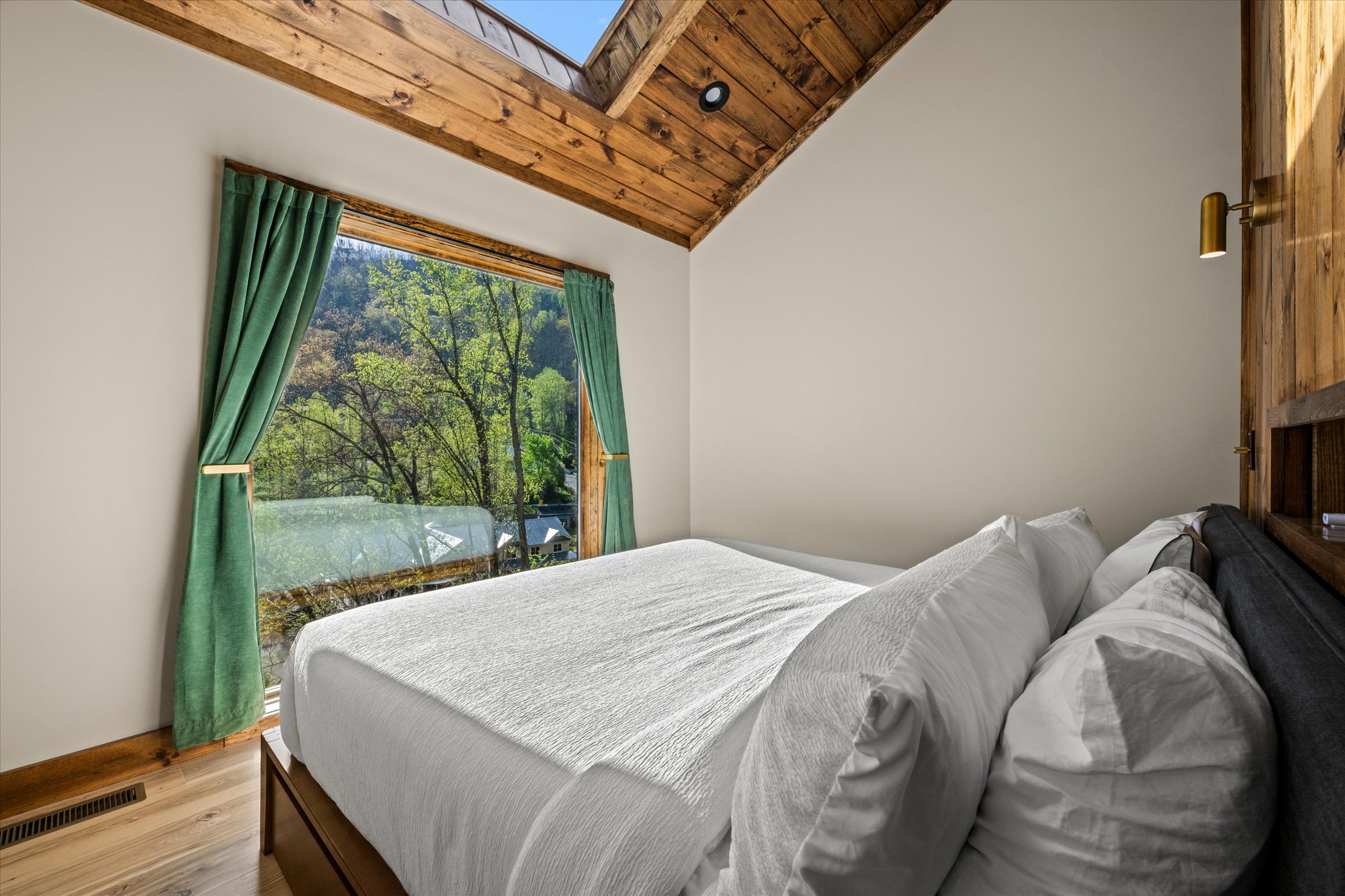 The bedroom features a large 7' window and skylight window