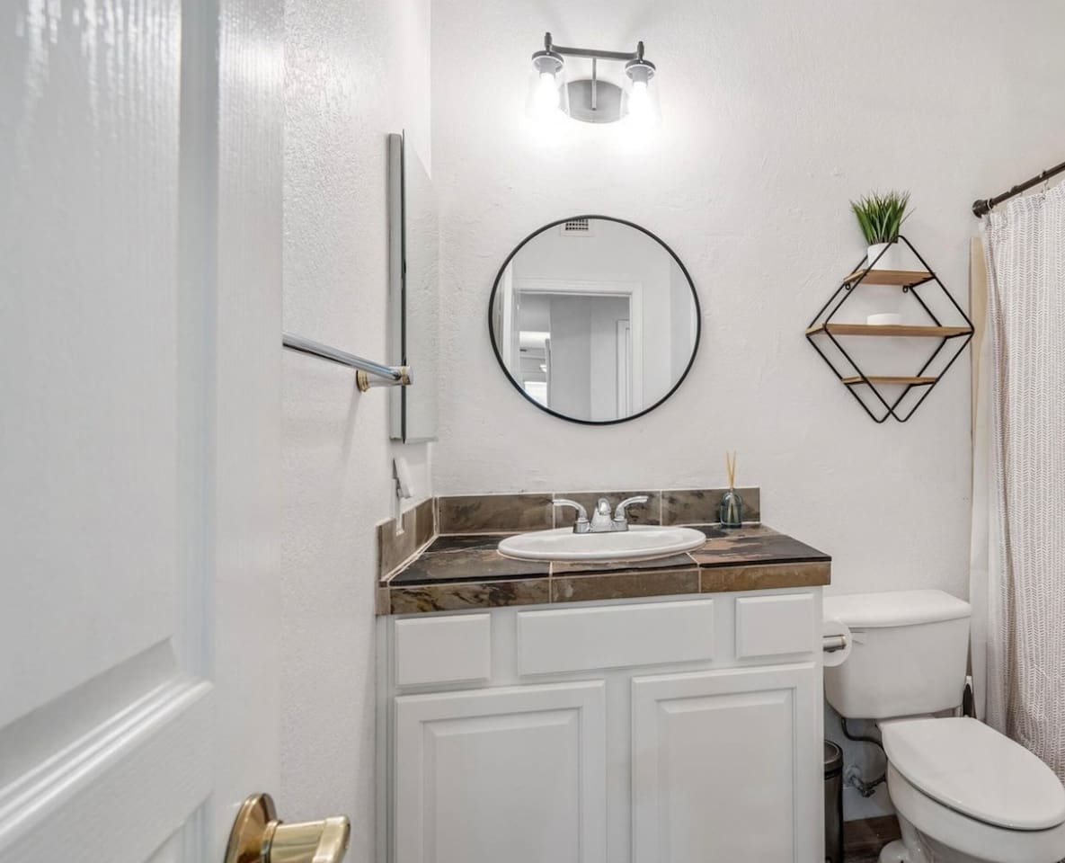 Bathroom with vanity storage, walk-in shower, soaking tub, and clean updated finishes for daily routines.