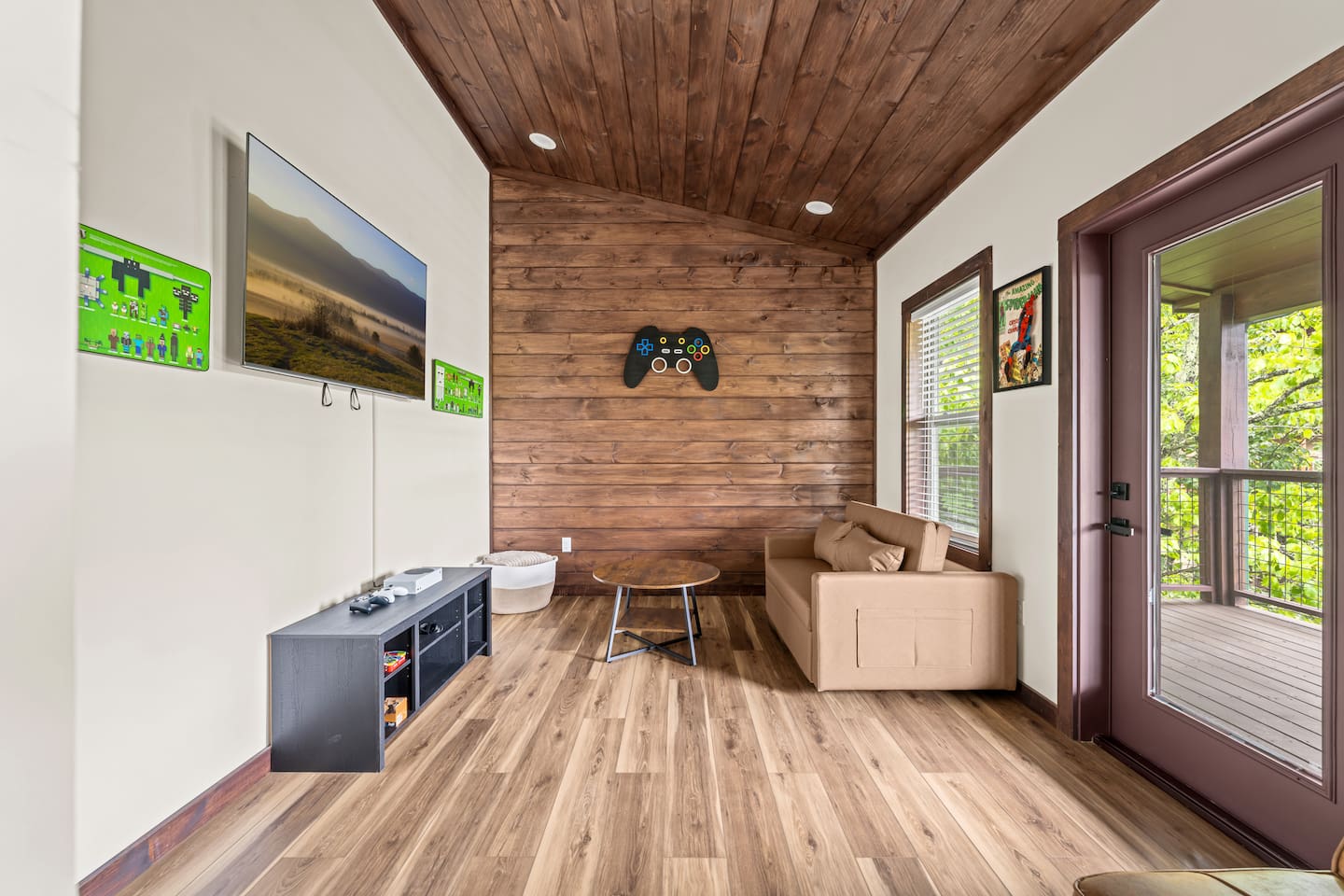 game room with xbox gaming system and also a arcade style gaming system, with 2 sleeping sofas