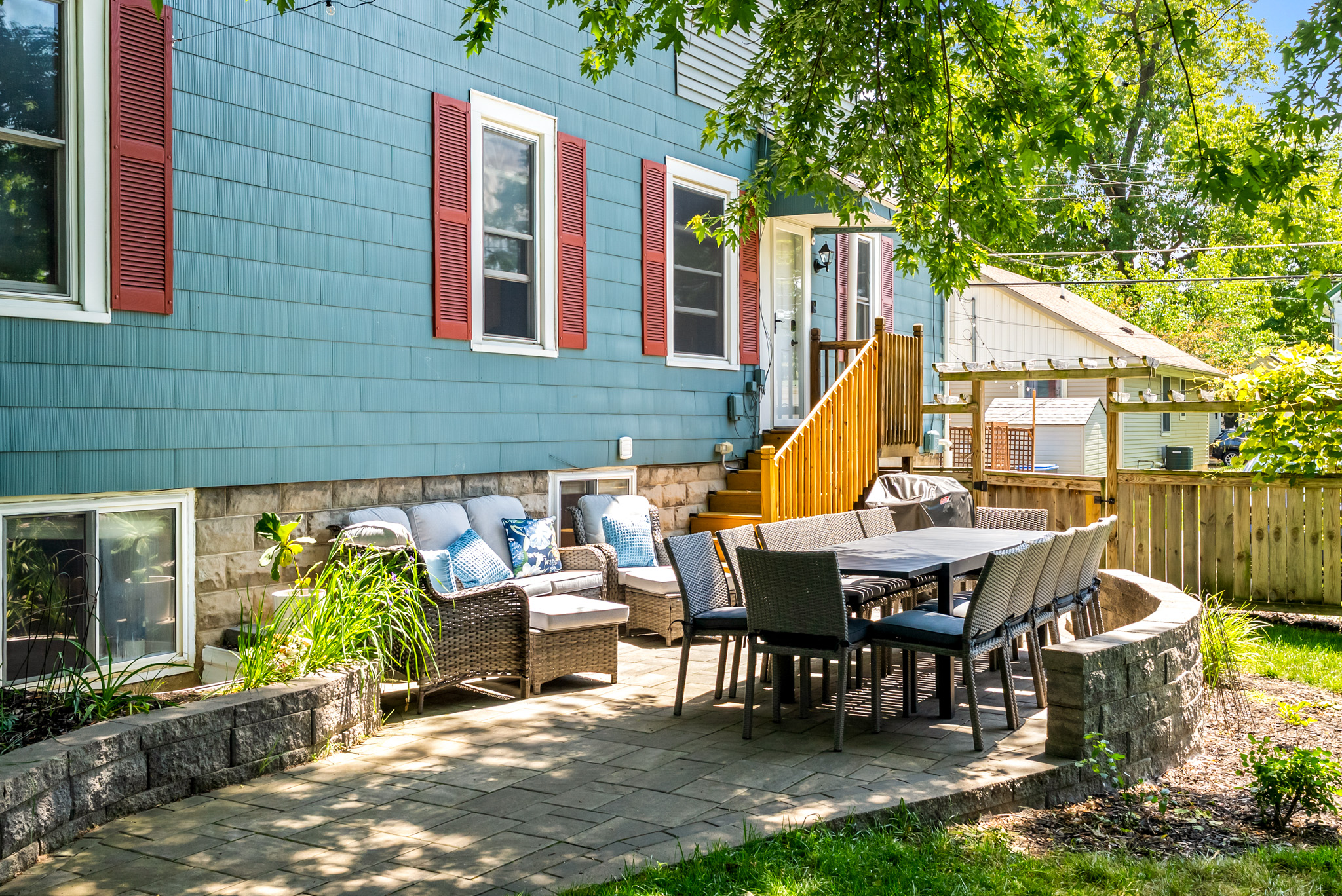 Al Fresco Dining & Lounge. Our private stone patio features a large dining table that seats fourteen and a comfortable wicker conversation area.

