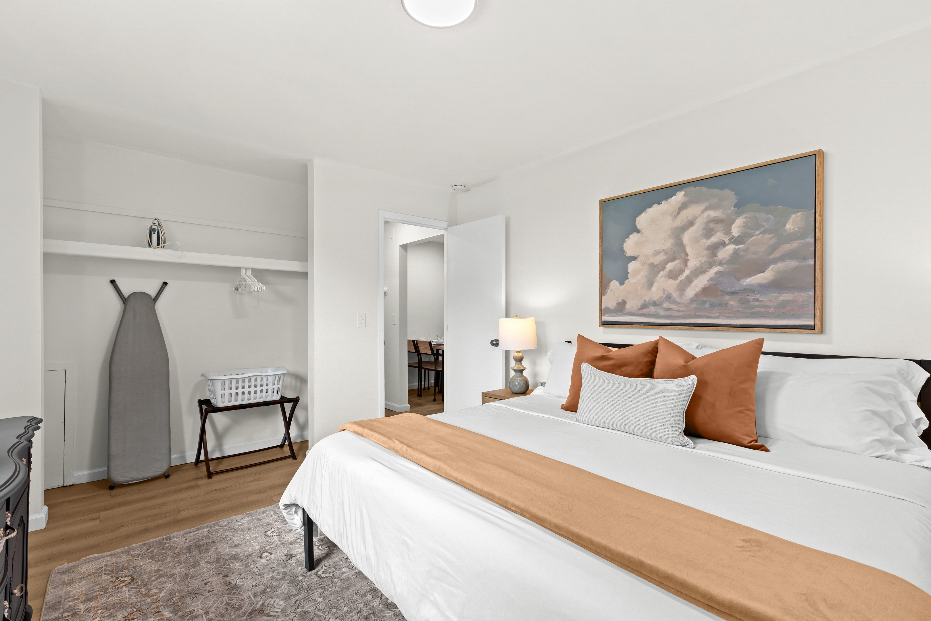 Spacious and serene bedroom featuring a plush king bed, cozy linens, and ample closet space for a comfortable stay.