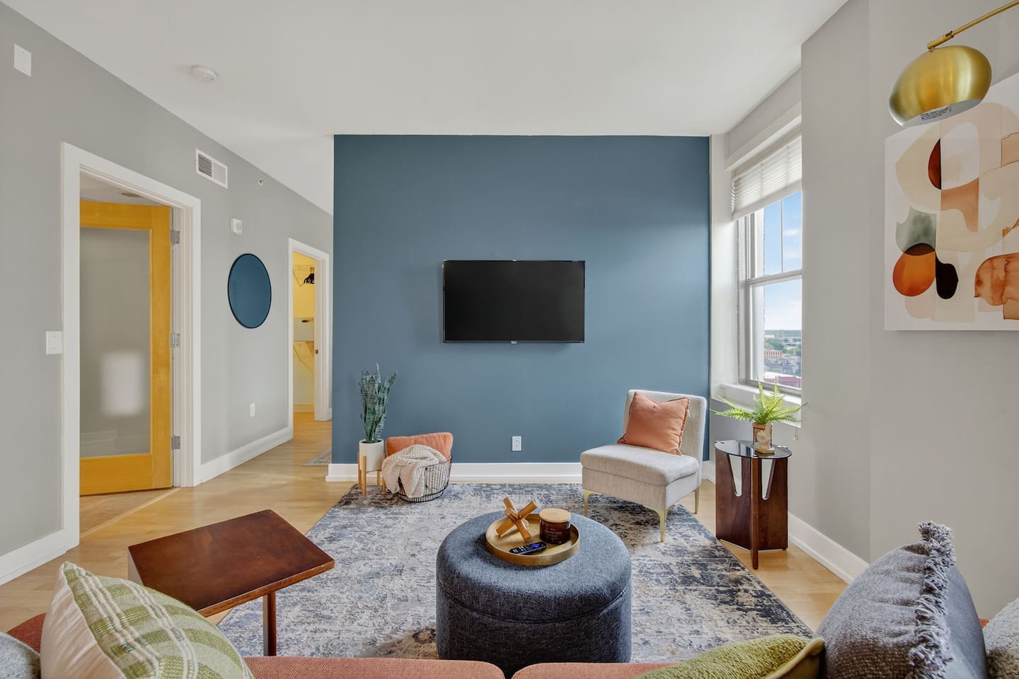 Gather around this stylish lounge with a wall-mounted TV, cozy seating, and contemporary design. A perfect place to unwind after exploring downtown Des Moines, complete with skyline views and warm decor.