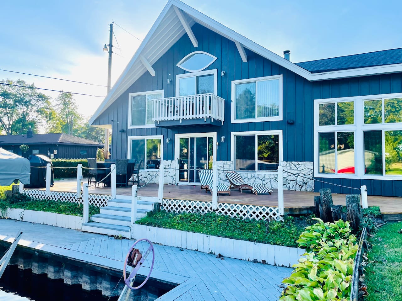 Lakefront exterior view of the home with private dock access.