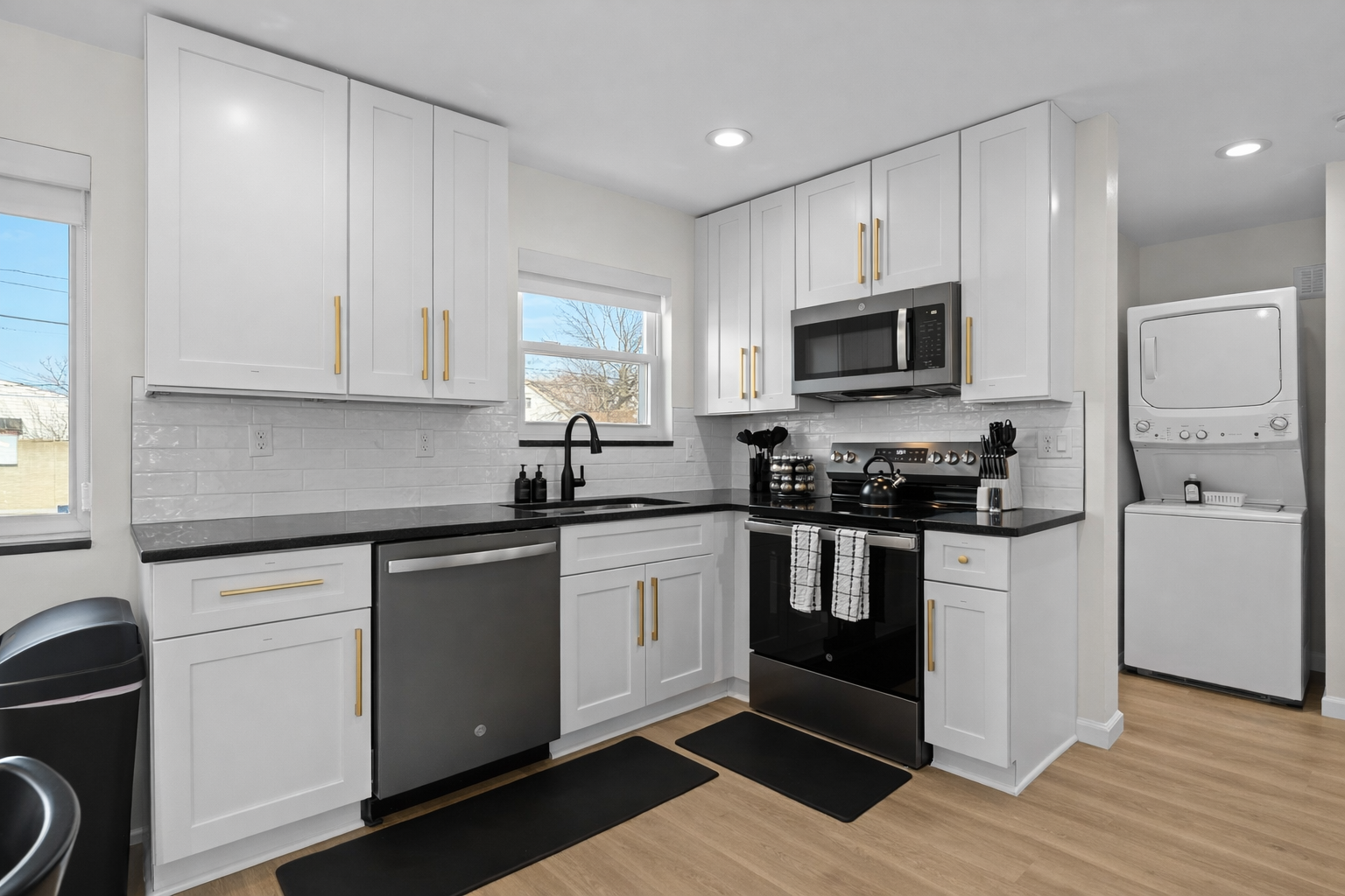 Bright, fully equipped kitchen with modern appliances, sleek finishes, and in-unit laundry—designed for easy meals and extended stays.