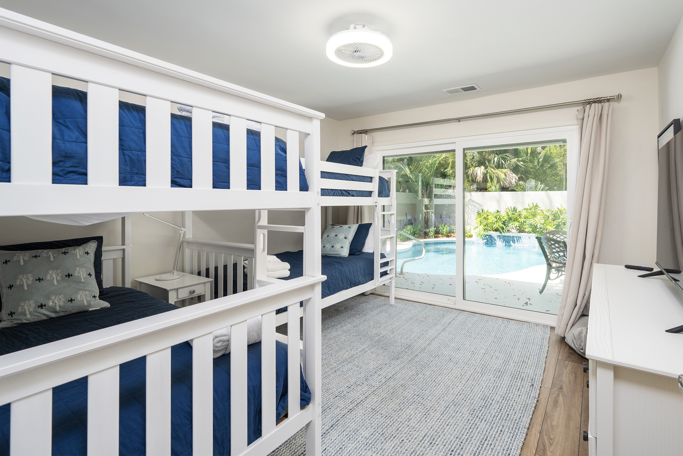 Kid's bunkroom features 4 twin beds