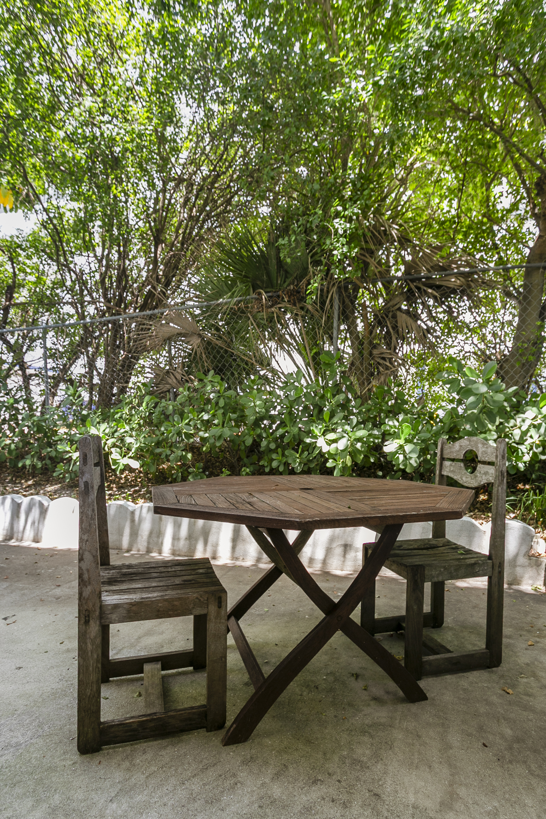Shaded outdoor seating with a teak table for two