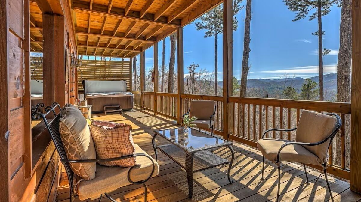 Lower-level deck with private hot tub, comfortable seating, and expansive Blue Ridge Mountain views - perfect for unwinding under the open sky.