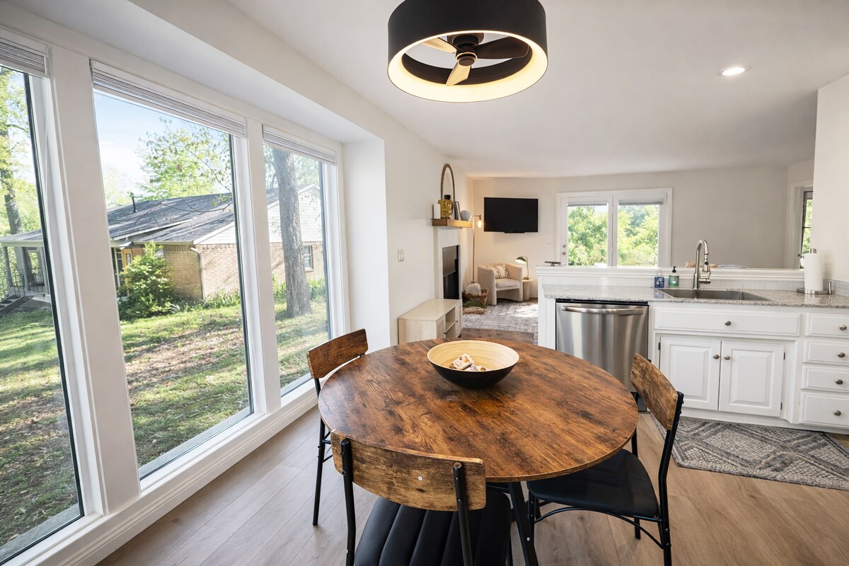 A charming dining nook bathed in natural light from the surrounding windows.