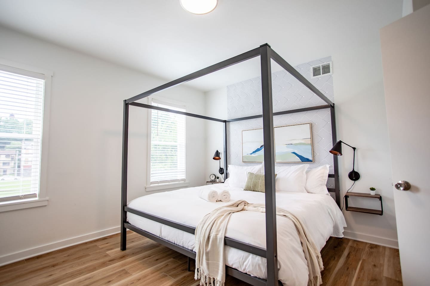 Cozy bed with a stylish bedframe, offering both comfort and a modern aesthetic that enhances the overall look of the room.