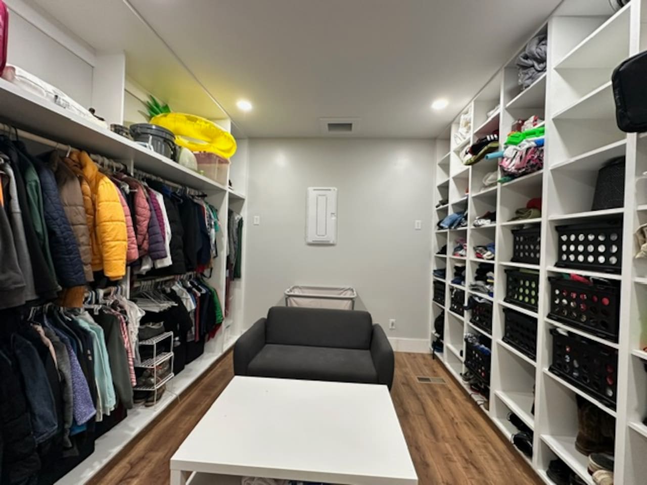 This massive laundry room includes a laundry chute from 2nd floor, a giant rolling laundry cart, a place to sit and fold clothes, and a table to organize. Plenty of space here to store your items that you don't need in your bedrooms during your stay.
