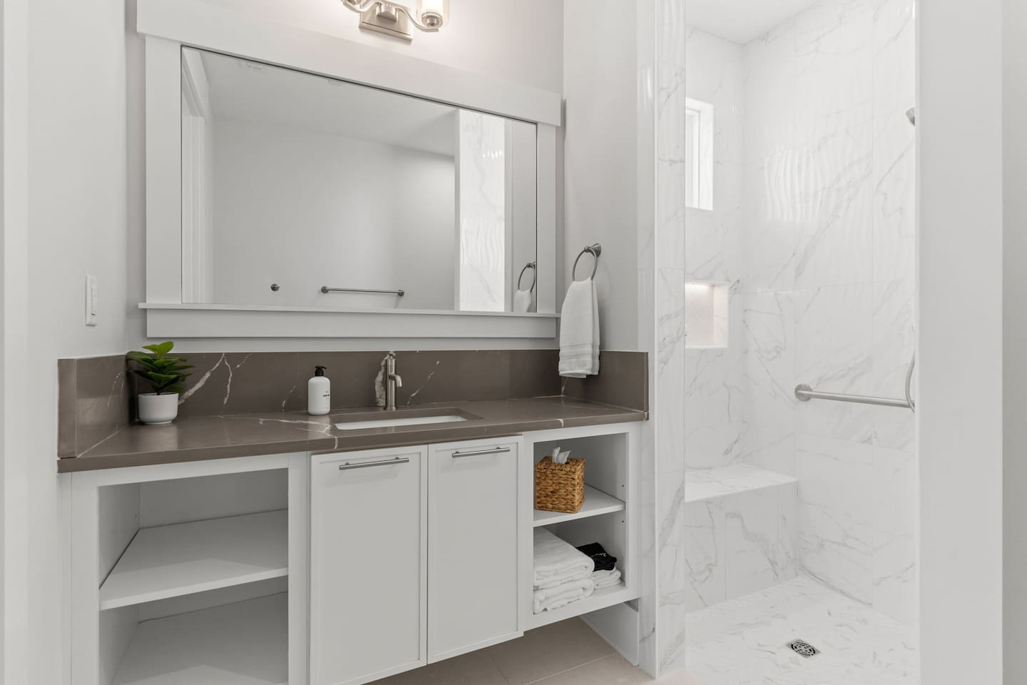 This bathroom is thoughtfully designed with mobility & accessibility in mind. Featuring grab bars at the toilet + shower for added safety & convenience, this spacious bathroom also provides a 5-foot turning radius to accommodate wheelchair users.