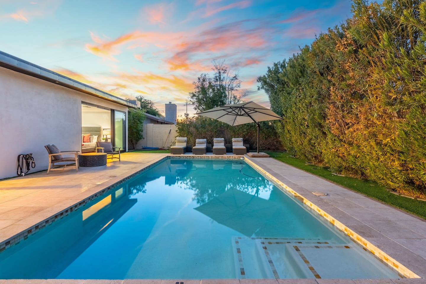 As twilight sets in, the pool glows under the soft sky—creating the perfect vibe for a relaxing swim or evening dip.