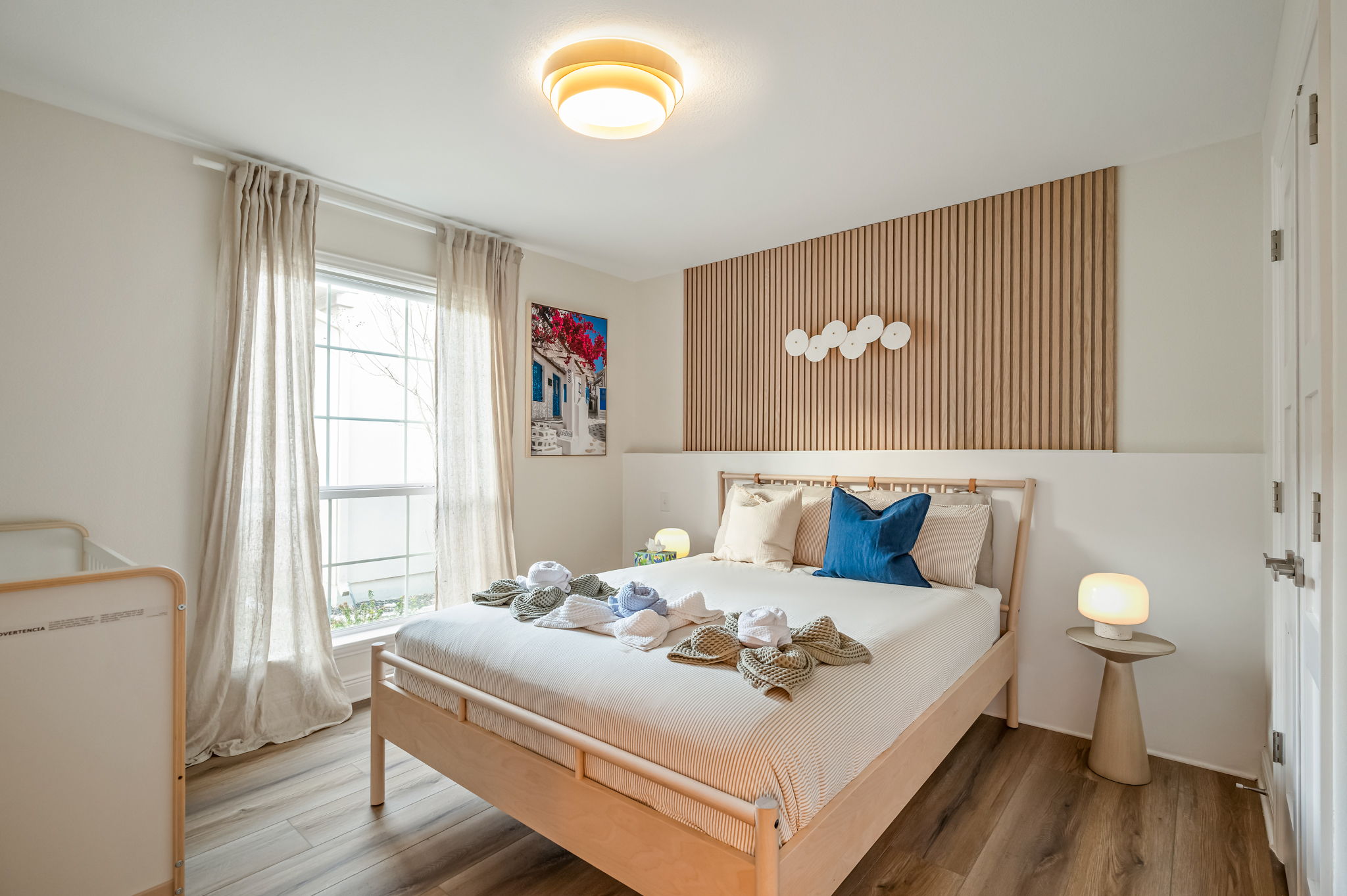 Cozy queen bedroom with soft neutral tones and relaxing natural light.