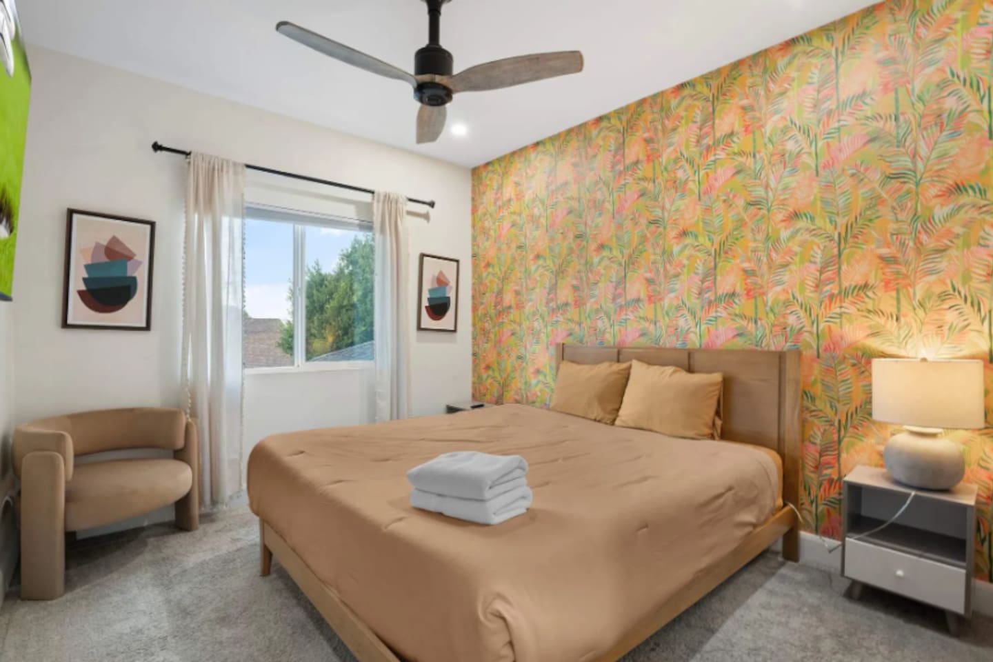 Cozy guest bedroom with bold tropical wallpaper.