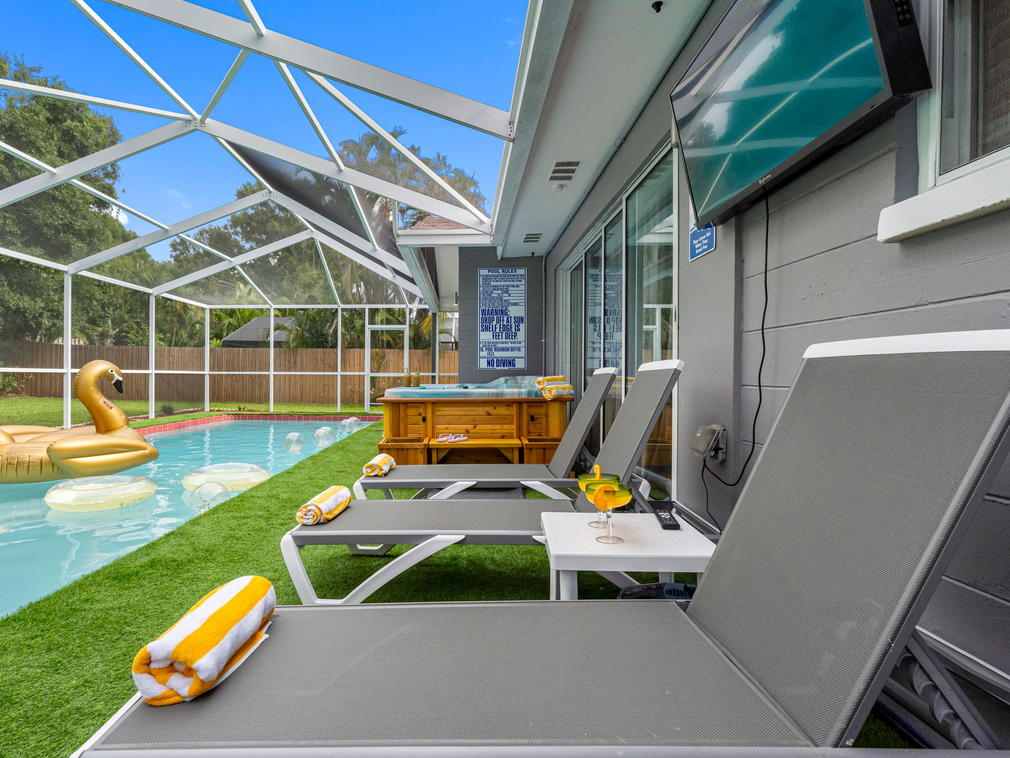Whether you're sunbathing with a drink or enjoying an evening dip under string lights, this pool deck has your vibe covered.