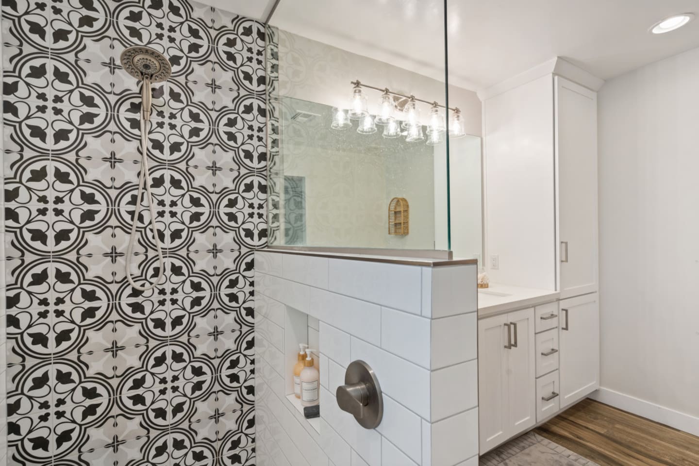 Ensuite bathroom with double sinks, tall storage cabinet, and a stylish walk-in shower.