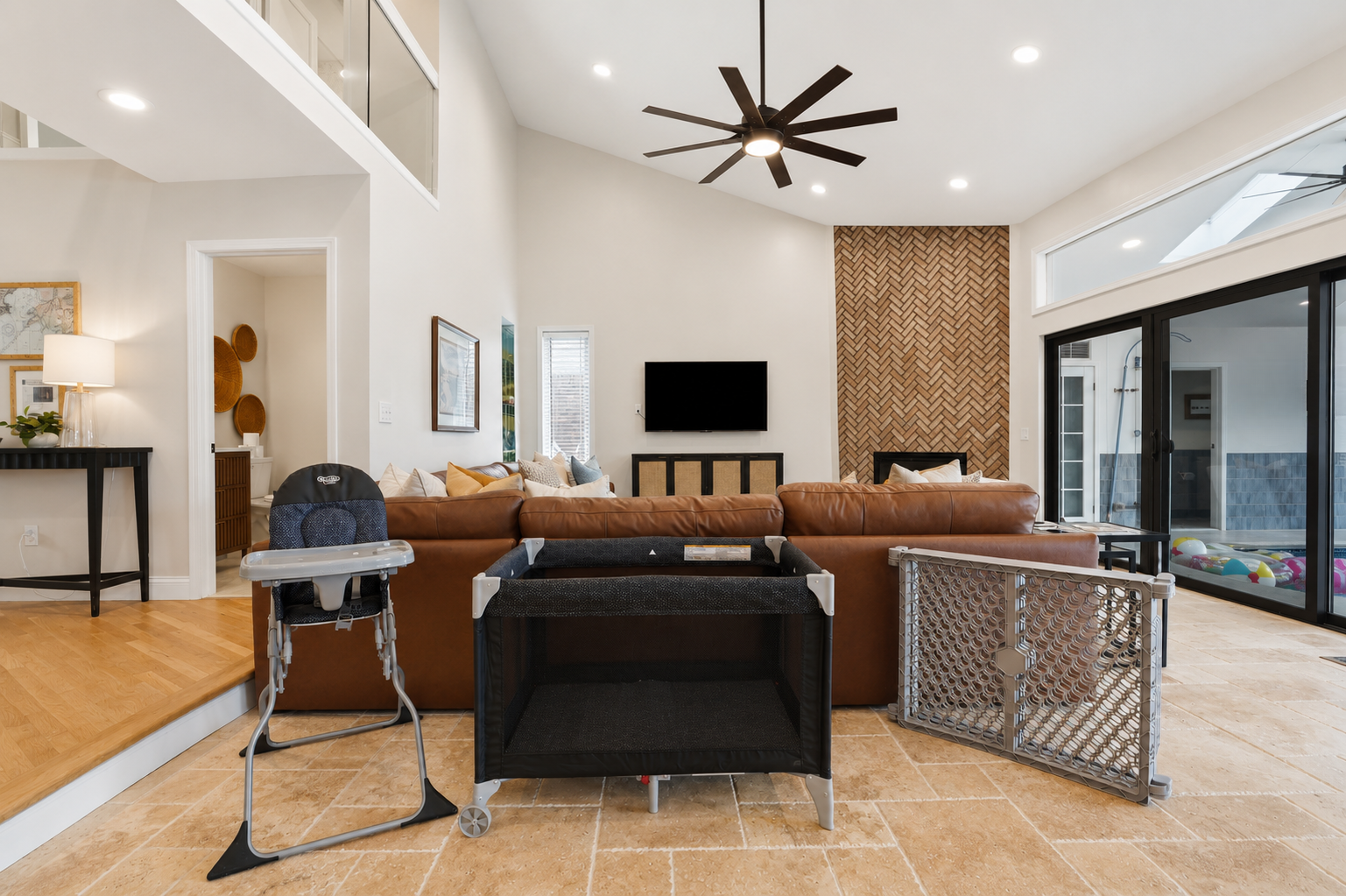 Modern open-concept living room with high ceilings, stylish seating, and seamless indoor-outdoor flow. Bright, spacious, and perfect for relaxing or entertaining.
