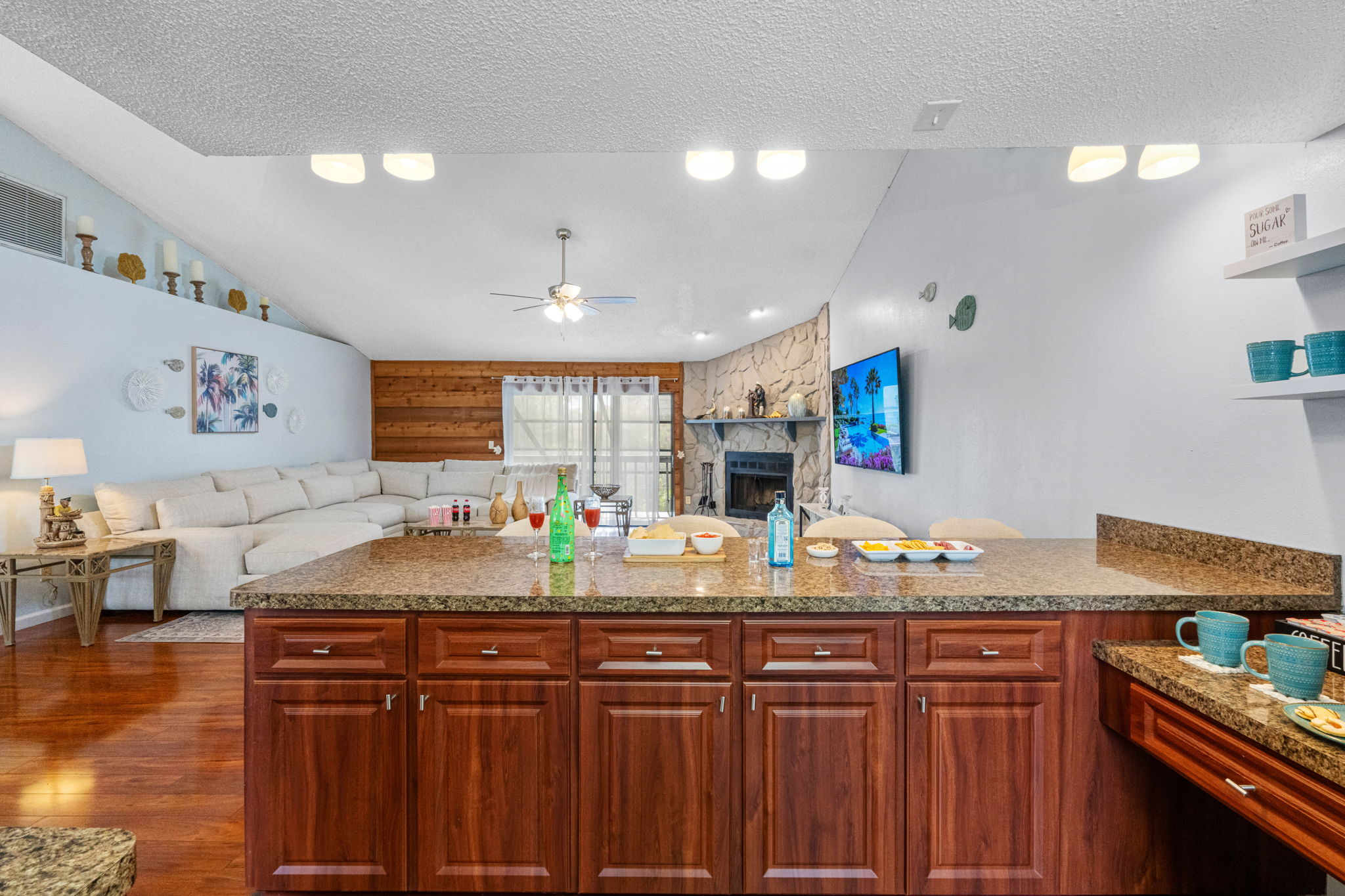The kitchen is lined with deep cherry wood cabinets that provide a sense of warmth and elegance.