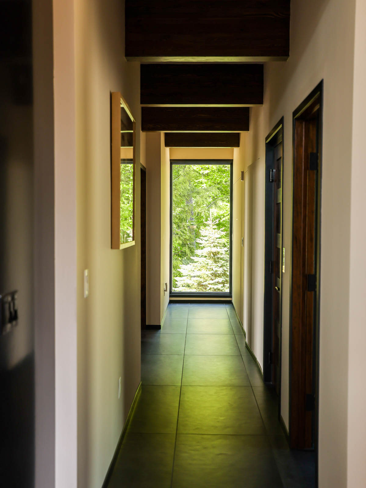 North hall hallway at Sunset Falls &mdash; main level, sliding door to guest rooms beyond