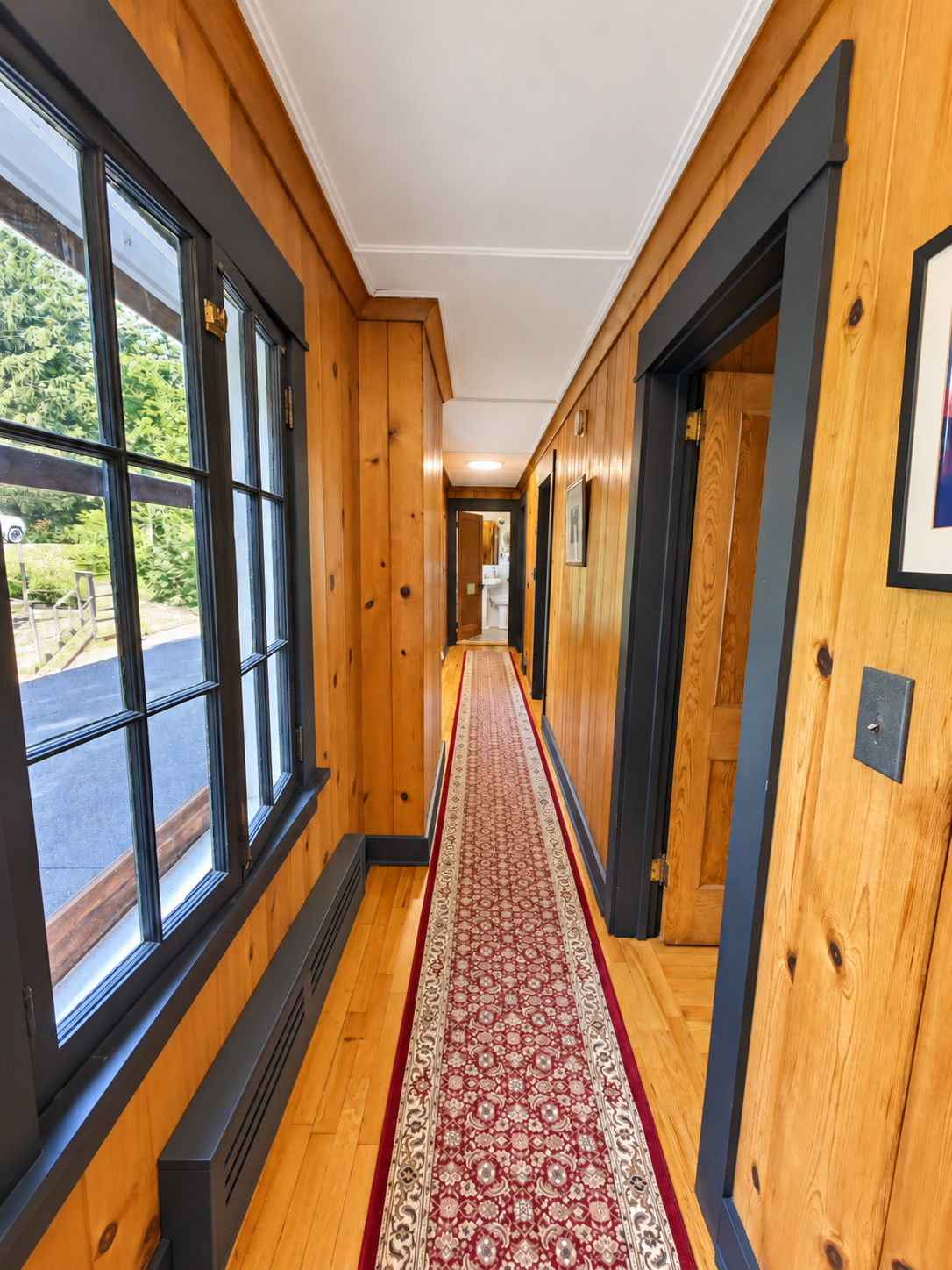 2nd floor hallway w/ doors to each of the three separate 2 bedroom suites