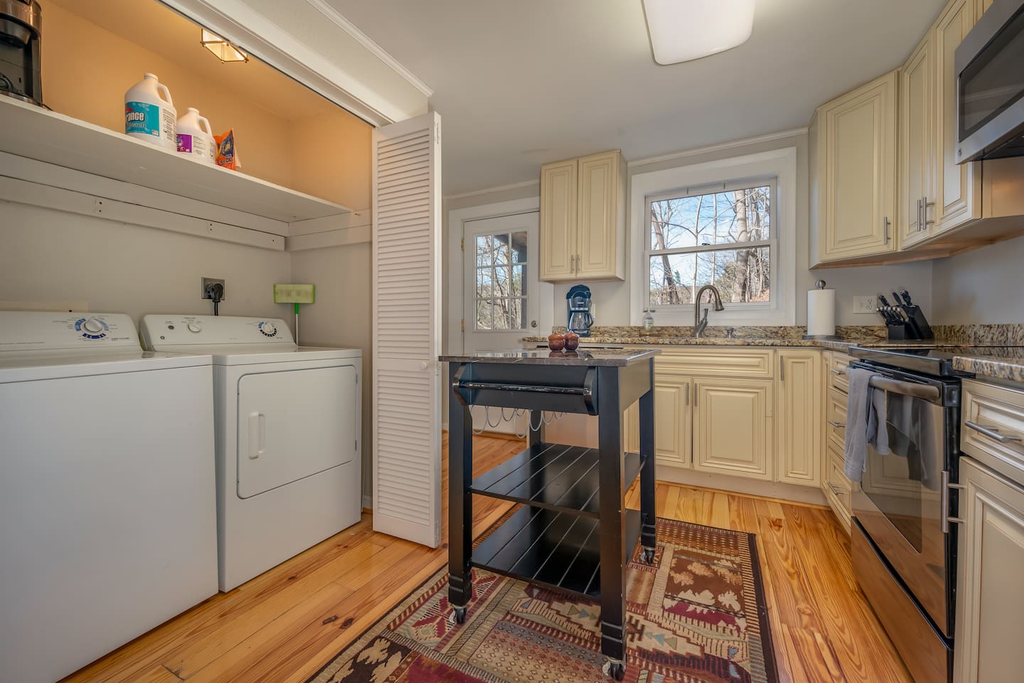 Kitchen area of the cabin with updated modern appliances plus laundry room