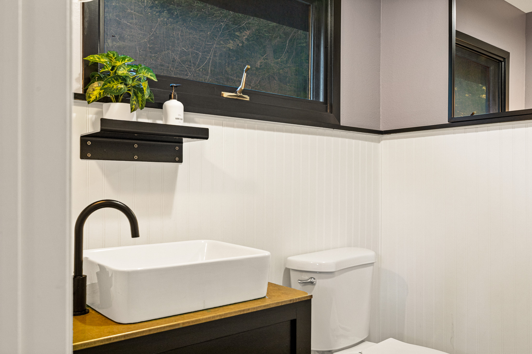 Beautifully designed 1/2 bathroom on the top level, with easy access from the common areas and kitchen.