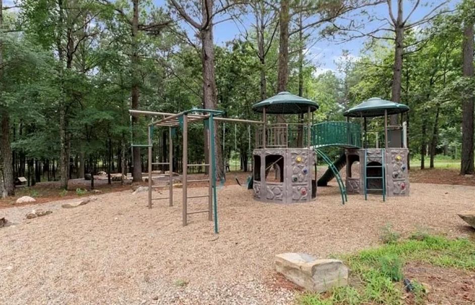 Family-friendly playground area surrounded by peaceful nature views