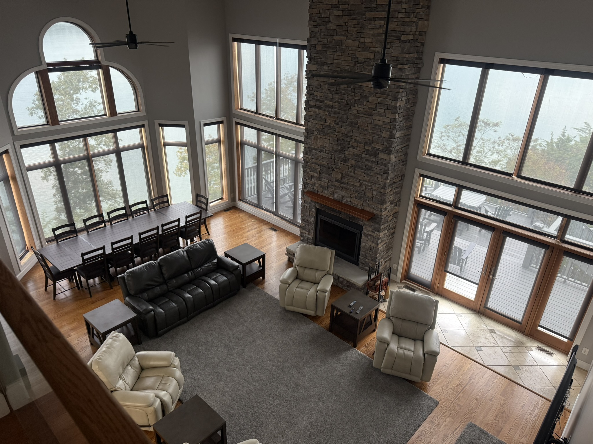 Living room with 20 ft ceiling, large windows with full view of Douglas Lake and Mountains on multiple sides, with doors to 2 porches (one out back and one next to the kitchen)