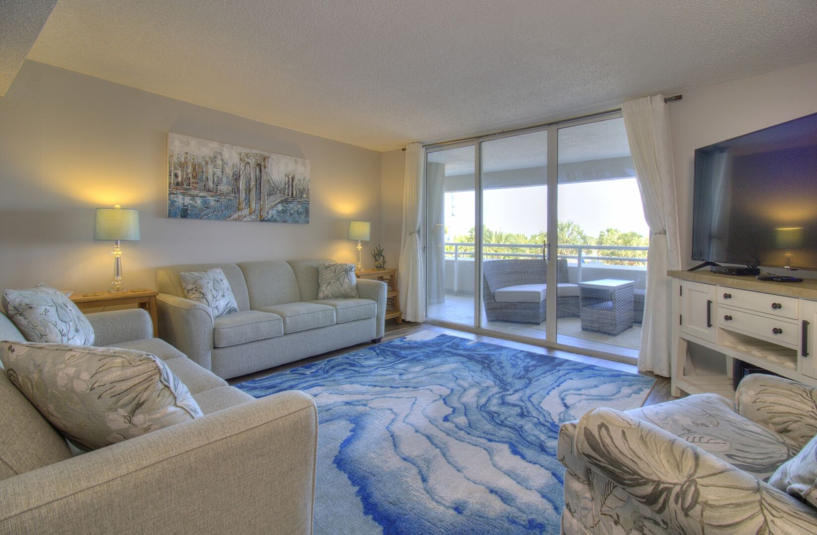 Beautiful OceanFront Lving area with balcony access, sleeper sofa and large TV