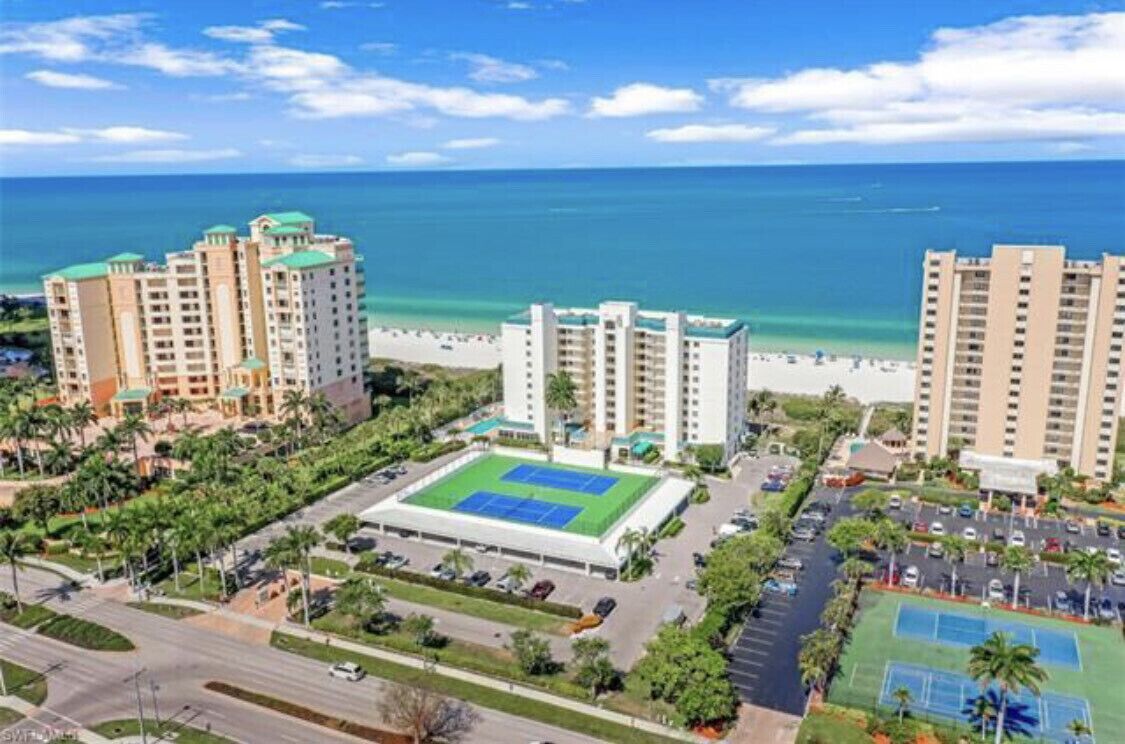 Building front view and tennis courts
