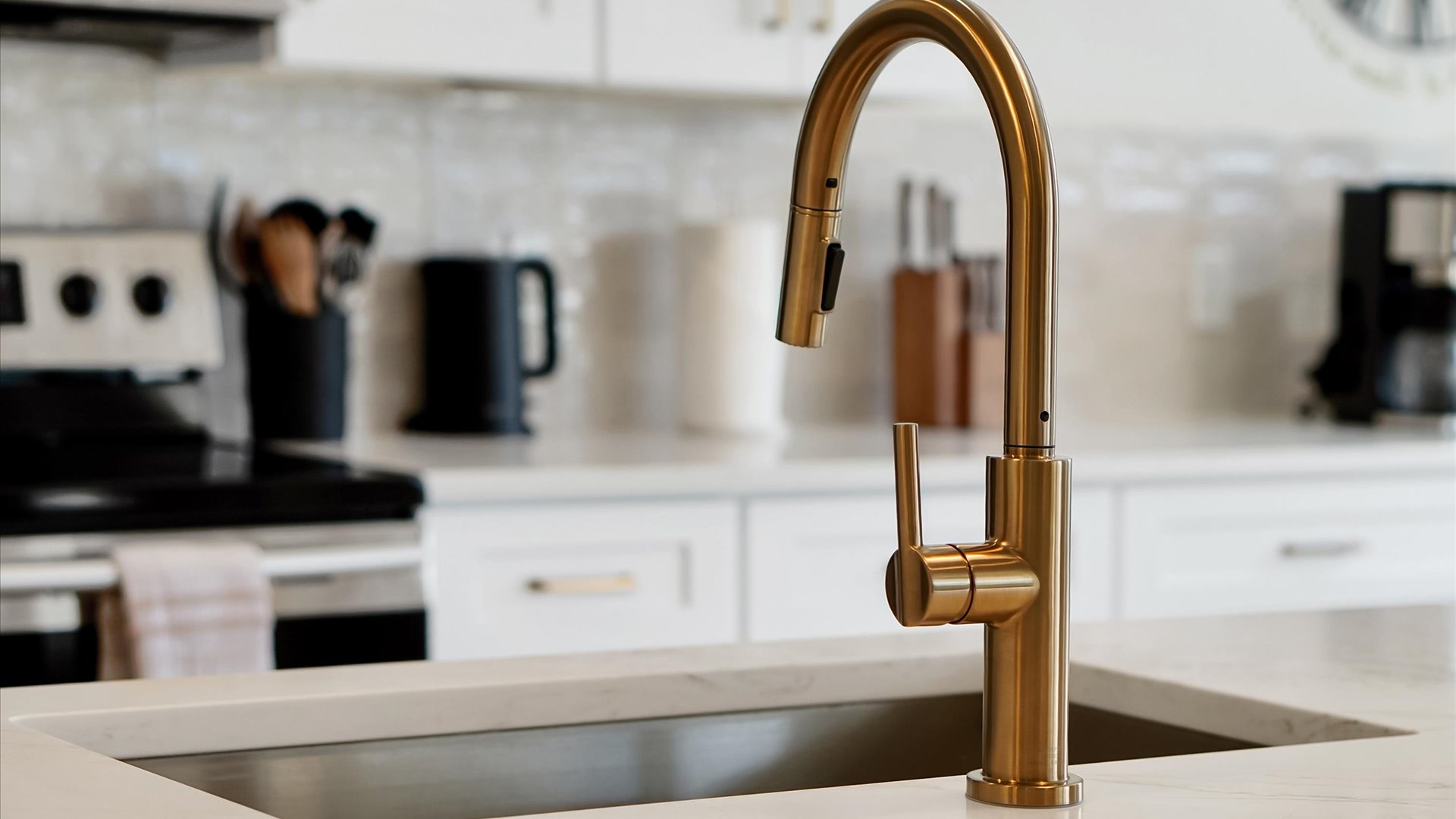 Kitchen Detail: Modern pull-down faucet and deep stainless-steel sink in the spacious kitchen island.