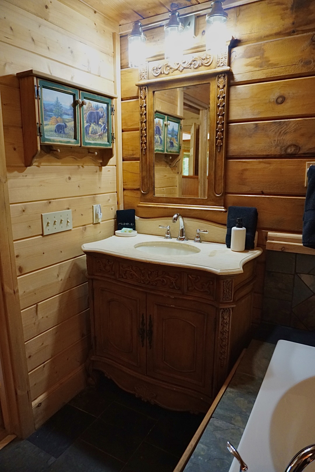 Rustic elegance. This charming bathroom vanity adds a touch of mountain style to your stay.