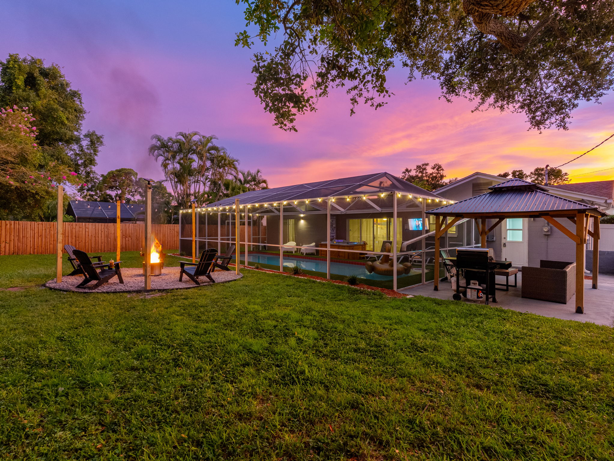 Watch the sky light up with color as the fire crackles—this serene backyard setup is the kind of place memories are made.